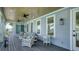 Relaxing balcony features comfortable seating, ceiling fans, and beautiful water views at 630 De Narvaez Dr, Longboat Key, FL 34228
