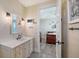 Well-lit bathroom featuring a vanity with drawers and is next to bedroom at 630 De Narvaez Dr, Longboat Key, FL 34228