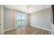 A well-lit bedroom features a sliding glass door with a waterfront view at 630 De Narvaez Dr, Longboat Key, FL 34228