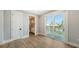 A bright bedroom is adjacent to a bathroom and features a sliding glass door with a view at 630 De Narvaez Dr, Longboat Key, FL 34228