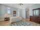 Light-filled bedroom features wood floors, plantation shutters, and traditional furnishings at 630 De Narvaez Dr, Longboat Key, FL 34228