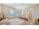 Comfortable bedroom with natural light, hardwood floors, and a ceiling fan at 630 De Narvaez Dr, Longboat Key, FL 34228