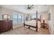 This primary bedroom boasts a four-poster bed, water views, and an abundance of natural light at 630 De Narvaez Dr, Longboat Key, FL 34228