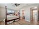 Inviting bedroom with a four-poster bed, light-filled windows, and an ensuite bath at 630 De Narvaez Dr, Longboat Key, FL 34228