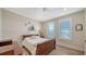 Cozy bedroom with light-filled windows, hardwood floors, and a ceiling fan at 630 De Narvaez Dr, Longboat Key, FL 34228