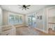 Serene bedroom with light-filled windows, a ceiling fan, and access to the deck at 630 De Narvaez Dr, Longboat Key, FL 34228