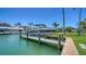 Private boat dock with a boat lift, providing convenient waterfront access and protection for your vessel on a sunny day at 630 De Narvaez Dr, Longboat Key, FL 34228
