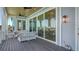 Spacious, covered deck with outdoor furniture, offering beautiful views of the serene surroundings and seamless access to the indoors at 630 De Narvaez Dr, Longboat Key, FL 34228