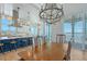 Open concept, eat in kitchen with large island, chandelier, and waterfront views at 630 De Narvaez Dr, Longboat Key, FL 34228