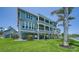 Beautiful three-story home featuring large porches on a well manicured lawn at 630 De Narvaez Dr, Longboat Key, FL 34228