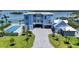 Exterior of waterfront property with lush greenery, private pool, and brick driveway at 630 De Narvaez Dr, Longboat Key, FL 34228