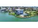 Exterior view of home on the water featuring a pool, grassy yard and balconies at 630 De Narvaez Dr, Longboat Key, FL 34228