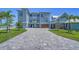 Exterior front view of luxury home featuring lush landscaping, a paved driveway and a garage at 630 De Narvaez Dr, Longboat Key, FL 34228