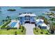 Luxury coastal property, showcasing an in-ground pool, stone driveway and waterfront views at 630 De Narvaez Dr, Longboat Key, FL 34228