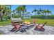 Outdoor fire pit area with comfortable seating, perfect for entertaining at 630 De Narvaez Dr, Longboat Key, FL 34228