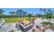 Stone fire pit with Adirondack chairs located in the back yard of the property at 630 De Narvaez Dr, Longboat Key, FL 34228