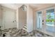 Bright foyer with striking tile flooring and staircase offers direct access to the pool area at 630 De Narvaez Dr, Longboat Key, FL 34228