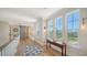 Bright hallway featuring hardwood floors, natural light, and classic woodwork at 630 De Narvaez Dr, Longboat Key, FL 34228