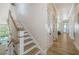 Hallway with wooden floors, a staircase, white walls and trim, and water views at 630 De Narvaez Dr, Longboat Key, FL 34228
