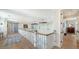 A bright hallway featuring hardwood floors, white railings, and views of the water at 630 De Narvaez Dr, Longboat Key, FL 34228