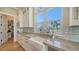 Bright kitchen features white cabinets, stainless steel appliances, and a view of the water at 630 De Narvaez Dr, Longboat Key, FL 34228