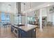 Bright kitchen with a large island, cooktop, and open to the dining and living areas at 630 De Narvaez Dr, Longboat Key, FL 34228