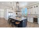 Bright kitchen features a large island, modern stainless-steel appliances, and ample counter space at 630 De Narvaez Dr, Longboat Key, FL 34228