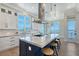 Bright kitchen features an island with barstool seating and views of the water at 630 De Narvaez Dr, Longboat Key, FL 34228