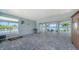 Covered lanai featuring tiled flooring, outdoor seating, and serene waterfront views at 630 De Narvaez Dr, Longboat Key, FL 34228