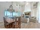 Elegant living room with stone fireplace, and open floor plan offering seamless access to a formal dining area and stunning water views at 630 De Narvaez Dr, Longboat Key, FL 34228