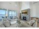 Bright living room with fireplace and access to a deck overlooking the water at 630 De Narvaez Dr, Longboat Key, FL 34228