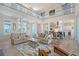 Spacious living room with two-story ceiling, open floorplan, and access to a balcony at 630 De Narvaez Dr, Longboat Key, FL 34228