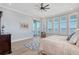 This light main bedroom features wooden floors, plantation shutters, and balcony access at 630 De Narvaez Dr, Longboat Key, FL 34228
