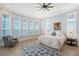 Bright main bedroom boasts plantation shutters, water views, wood floors, and a cozy chair at 630 De Narvaez Dr, Longboat Key, FL 34228