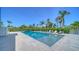Inviting swimming pool with lounge chairs surrounded by lush landscaping at 630 De Narvaez Dr, Longboat Key, FL 34228