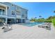 Backyard view of pool, surrounded by lounge chairs at 630 De Narvaez Dr, Longboat Key, FL 34228