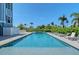 Inviting swimming pool with lounge chairs surrounded by lush landscaping at 630 De Narvaez Dr, Longboat Key, FL 34228