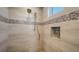 Modern shower features neutral tile, mosaic accents, niche and dual shower heads at 630 De Narvaez Dr, Longboat Key, FL 34228
