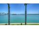 Stunning water view framed by palm trees, showcasing the serene beauty of the waterfront property at 630 De Narvaez Dr, Longboat Key, FL 34228