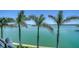 Enjoy gorgeous waterfront views framed by swaying palm trees from this luxurious property at 630 De Narvaez Dr, Longboat Key, FL 34228