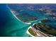 Aerial view showcases beautiful coastline with the ocean meeting the shore at 645 Liberty St, Englewood, FL 34223