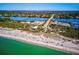 Aerial view of a beach community featuring waterfront access, a bridge, and lush green surroundings at 645 Liberty St, Englewood, FL 34223