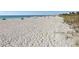 Expansive beach view with soft white sand and calm turquoise waters, perfect for relaxation at 645 Liberty St, Englewood, FL 34223