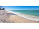 Scenic beach view with gentle waves lapping on the shore and a clear blue sky above at 645 Liberty St, Englewood, FL 34223