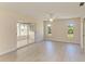Spacious bedroom featuring a ceiling fan, two windows, and a tiled sunroom at 645 Liberty St, Englewood, FL 34223