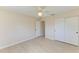 Bedroom featuring light-colored walls, wood-look floors, ceiling fan, and a closet at 645 Liberty St, Englewood, FL 34223