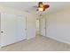Bedroom featuring light-colored walls, laminate wood flooring, ceiling fan, and closet with doors at 645 Liberty St, Englewood, FL 34223
