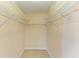 Empty closet featuring white wire shelving and laminate wood flooring at 645 Liberty St, Englewood, FL 34223