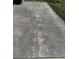 Close-up of the driveway showing the concrete and some stains on its surface at 645 Liberty St, Englewood, FL 34223