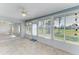 Bright Florida room with tile floor, multiple windows, and a ceiling fan at 645 Liberty St, Englewood, FL 34223